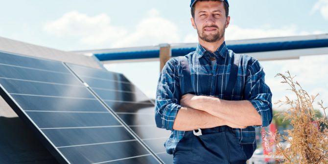 Young successful master of solar panel installation Young successful master of solar panel installation